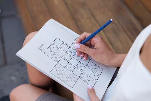 Person solving Sudoku for brain training